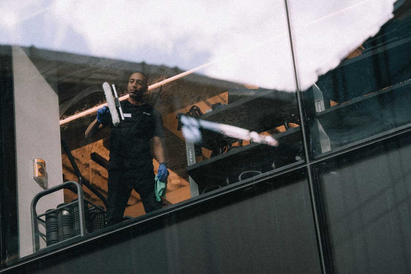A man cleaning windows on a tall building